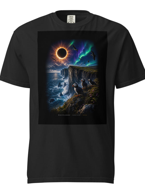 Black unisex t-shirt for the Iceland solar eclipse 2026, featuring Westfjords Látrabjarg cliffs totality design, shown flat lay on dark surface
